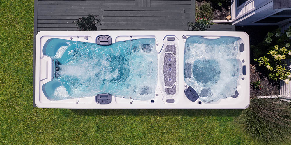 Vue prise par un drone directement au-dessus d'un spa de nage dont le système de propulsion est activé.
